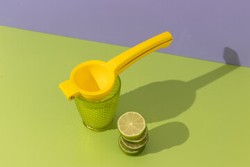 lemonade theme with fresh limes on green and lavender background, visible shadows, space for text