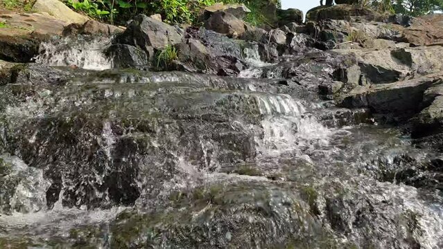 the water of the river flowing over rocks, lobe falls kribi Cameroon