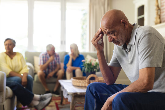 Group Of Emotional, Diverse Senior Friends In Living Room, Talking During Group Therapy Session