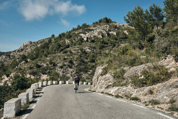 A professional cyclist's epic mountain ride.Male cyclist riding in the mountains.Man cyclist...