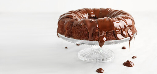 Dessert stand with tasty chocolate cake on white table