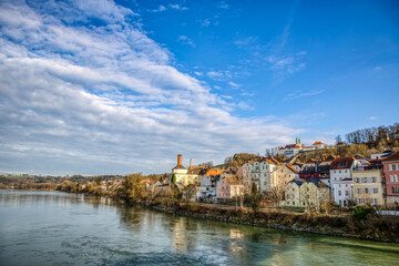Fototapeta na wymiar High dynamic range cityscape view of Passau city with view at the river inn in late afternoon with late afternoon sunlight in march