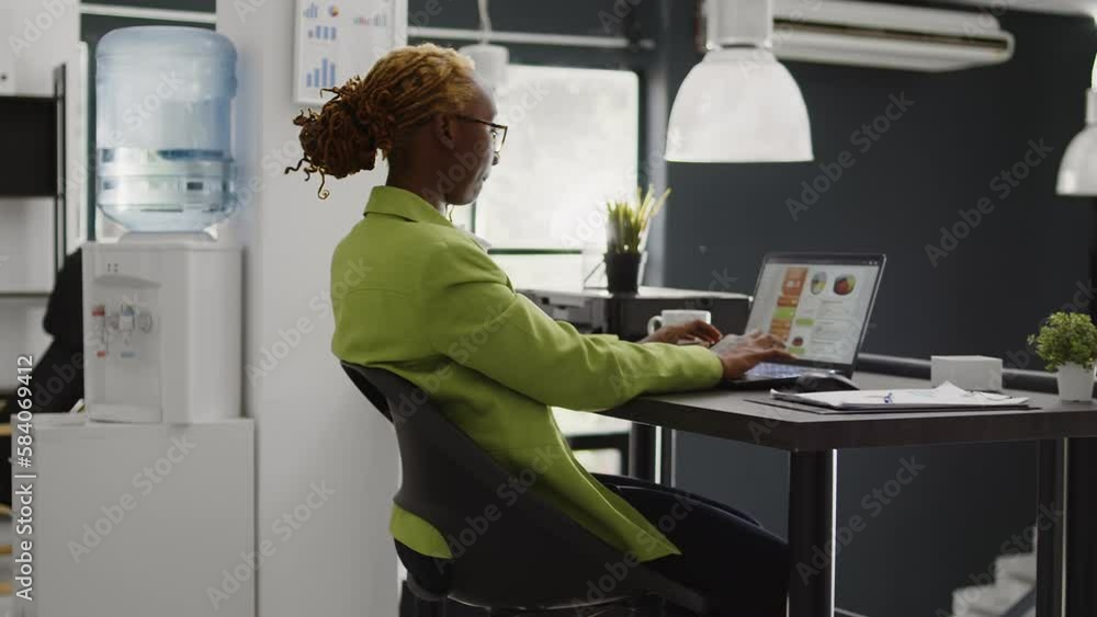 Poster female manager planning business strategy in office, looking at internet analytics on computer to cr