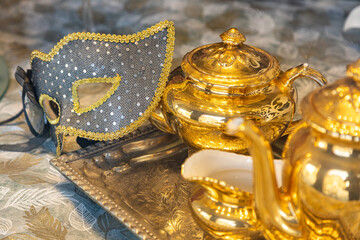 Beautiful Venetian mask with tray and golden teapot
