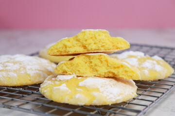 close up of delicious lemon cracked cookies with sugar powder on baking rack 