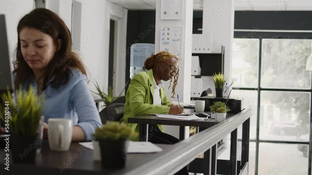 Aufkleber female assistant writing data on documents, taking notes on papers to create annual report. executiv