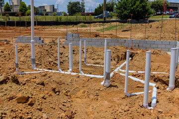 Fototapeta na wymiar It is job of plumber to lay sewage and water pipes utility lines in ground under foundation new home