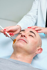 man getting a chemical peel in an aesthetic clinic