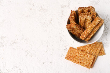 Bowl of sweet sesame kozinaki on light background