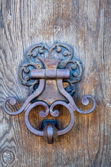 Metal knocker on a wooden door