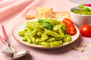 Plate with pesto pasta on table