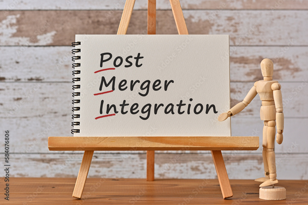 Poster there is notebook with the word post merger integration. it is an eye-catching image.
