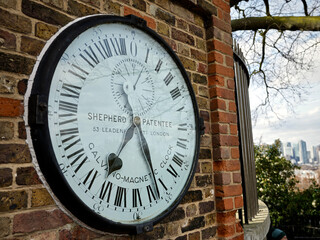 Fototapeta na wymiar old clock on the wall at greenwich england