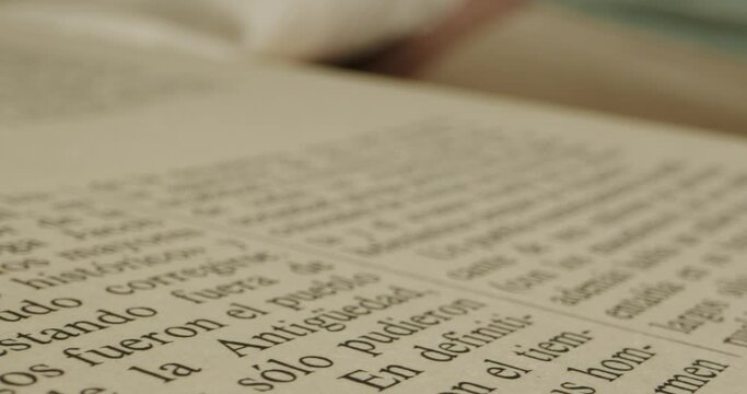 Close up of old Spanish language book with laowa probe lens on slider, macro of text in the book. Paper closeup.