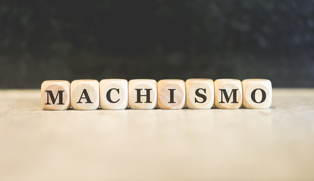 A palavra machismo em Português do Brasil escrita em dados de madeira.
