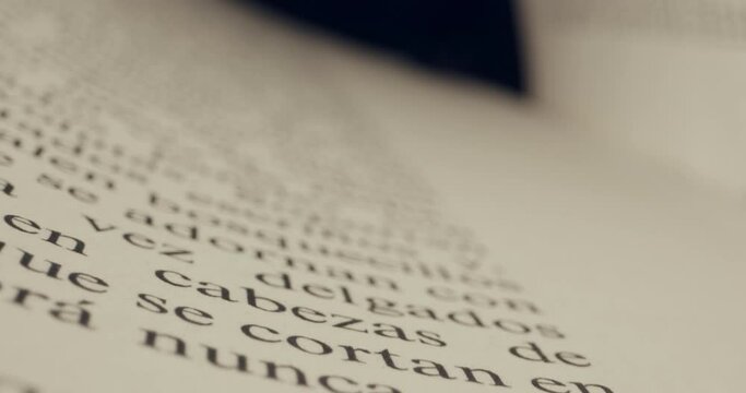 Close up of old Spanish language book with laowa probe lens on slider, macro of text in the book. Paper closeup.