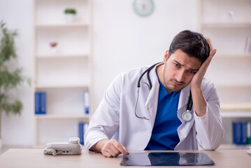 Young male doctor working in the clinic