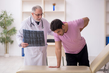 Young male patient visiting old male doctor radiologist