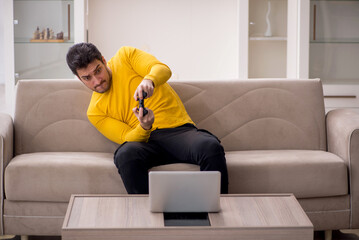 Young man playing video games at home