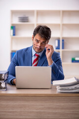 Young male employee working in the office