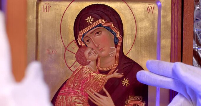 Expert determines the authenticity of an art object. Closeup, no face. An appraisal from a recognized authority or expert on the artist. Authenticating art is a verification of the authenticity.