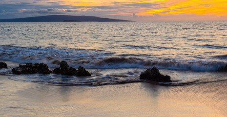 Fototapeta na wymiar Sunset Reflections Over Lava Rocks on Polo Beach, Maui, Hawaii, USa