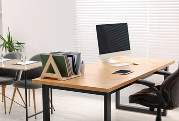 Director's office with large wooden table and comfortable armchairs. Interior design
