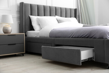 Storage drawer for bedding under modern bed in room
