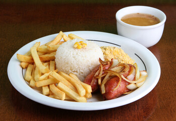 Sausage served with french fries, rice, beans and farofa