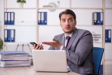 Young male employee working in the office