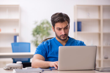 Young male doctor in telemedicine concept