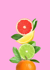 Stack of different fresh citrus fruits with green leaves on pink background