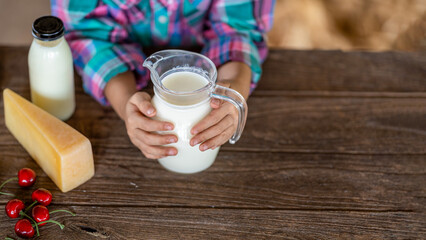 Fototapeta na wymiar Asian girl hand drinking Fresh milk from modern farm produce and dairy products, top view. , product concepts from dairy farms and health
