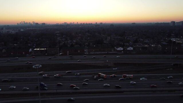 Car Crash Site On A Busy Highway, With Police And Firefighters Vehicles With Siren Lights On, At Sunset