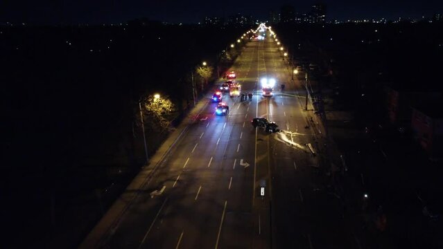 Aerial view, Emergency services response to road traffic accident on Brampton, Canada, quiet highway at night
