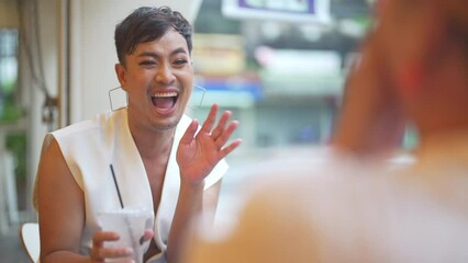 Two Asian drag queen gay friends in woman clothes meeting and drinking coffee together at coffee shop in the city. Diversity sexual equality, lgbtq pride people and transgender cross-dressing concept. - Powered by Adobe