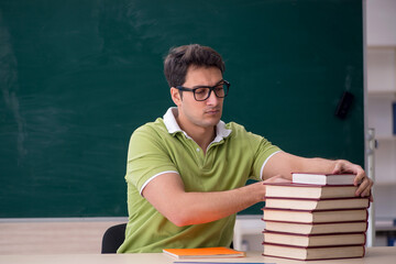 Young male student sitting in the classroom