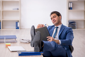 Young male employee working in the office