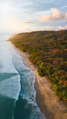 Aerial photography in Costa Rica, beach forest and ocean waves during sunset colors, amazing trip travel