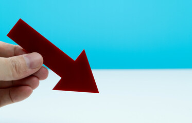 Hand holding red arrow symbol