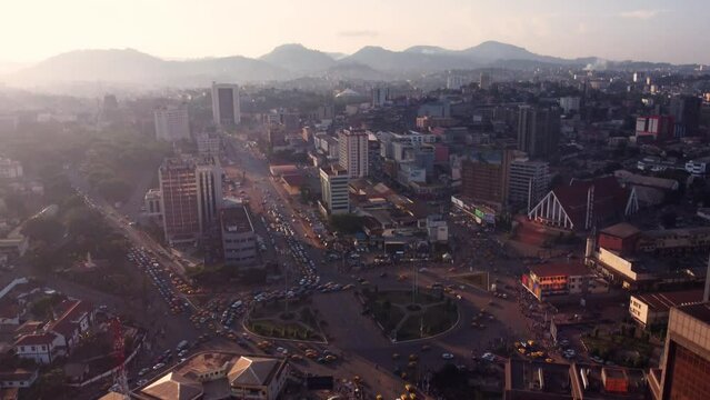 Cinematic aerial of downtown Yaounde, traffic at Poste Centrale roundabout