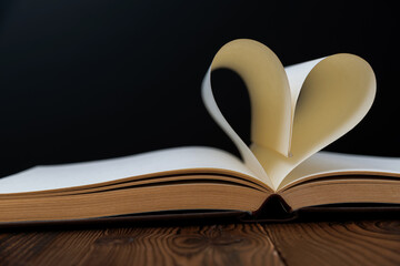 Book pages curved into heart shape
