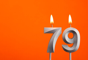 Candle number 79 - Birthday in orange background