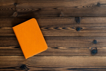 Orange book on wooden table
