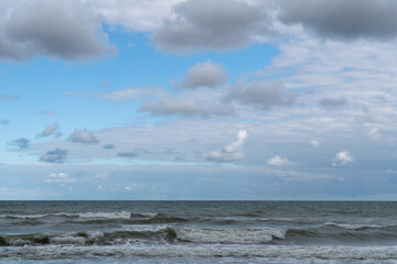 View of the stormy Baltic Sea against a cloudy sky on a sunny summer day, Curonian Spit,...
