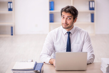 Young male employee working in the office