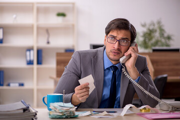 Young male accountant working in the office