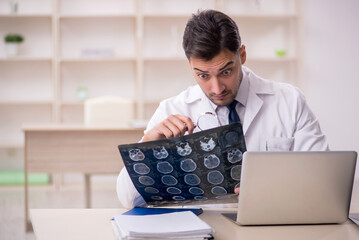 Young male doctor radiologist working in the clinic