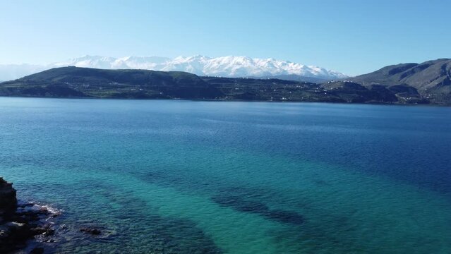 A Pull Back Reveal 4K Aerial Drone Footage Of The White Mountains Lefka Ori Of Crete, Over Small Islands Of Souda Bay.