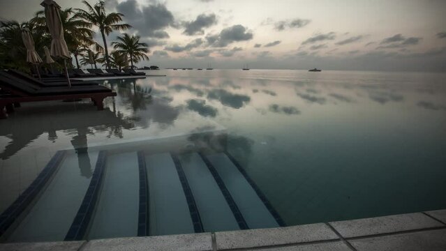 Time lapse of a sunrise in an infinity pool